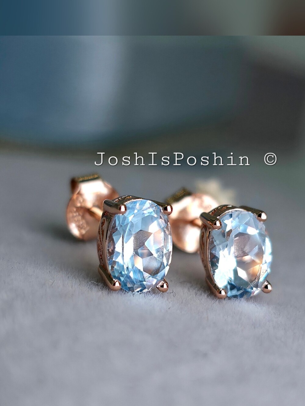 Oval Blue Topaz Stud Earrings In Sterling Silver